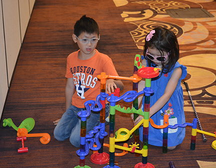Emerson and Joyce Bailey from Texas play with a construction toy at NFB Childcare.